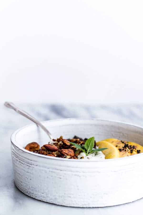 Coconut Banana Oats Smoothie Bowl with Crunchy Black Sesame Quinoa Cereal + Mango | halfbakedharvest.com