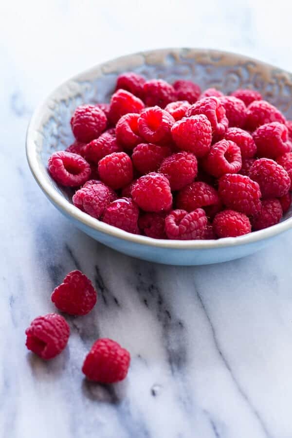 Vanilla Bean Coconut Quinoa Pudding with Honey Drizzled Raspberries | halfbakedharvest.com