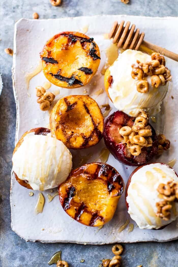 Cinnamon Grilled Peaches with Mascarpone Ice Cream | halfbakedharvest.com @hbharvest overhead photo of Cinnamon Grilled Peaches with Mascarpone Ice Cream on plate with honey drizzler