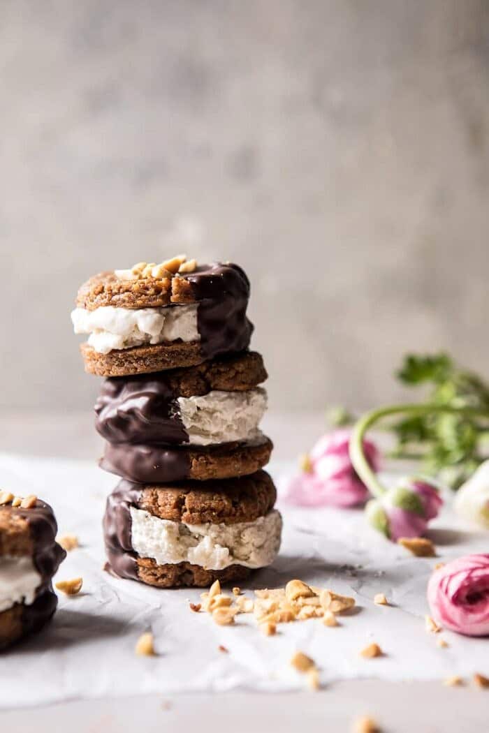 Chocolate Dipped Peanut Cookie Ice Cream Sandwiches | halfbakedharvest.com #icecream #chocolate #peanutbutter #summer far away, front on photo of Chocolate Dipped Peanut Cookie Ice Cream Sandwiches