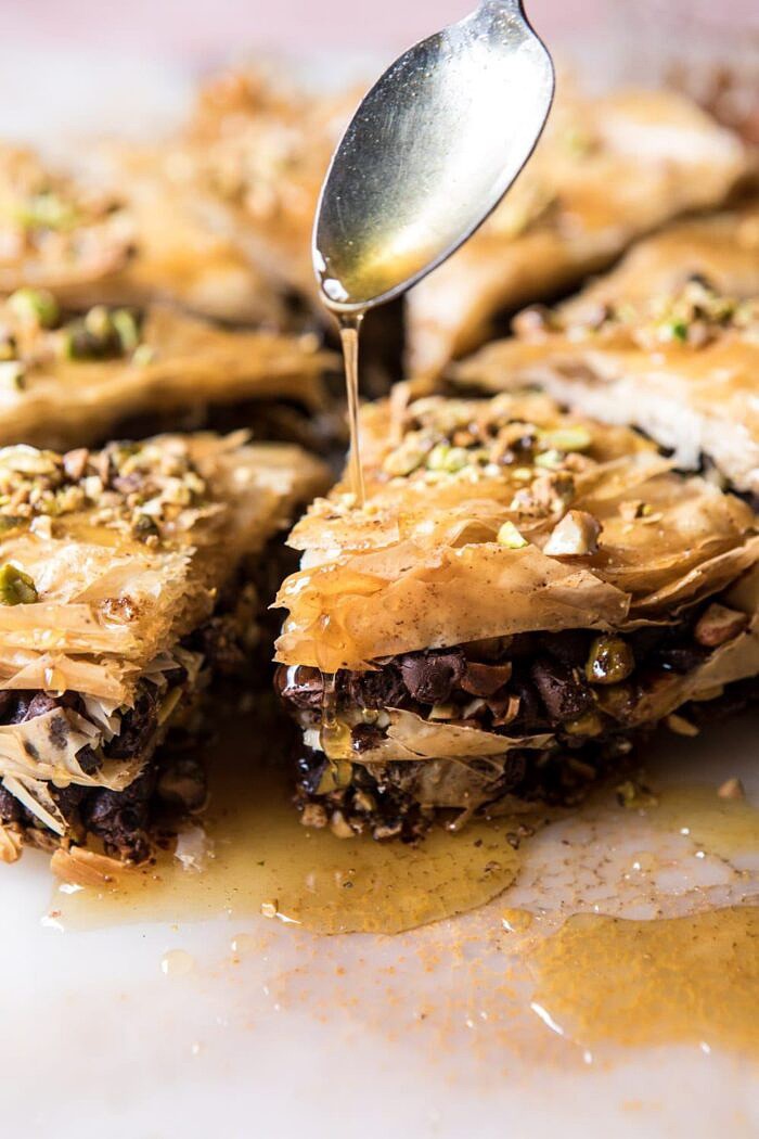 drizzling honey over Easy Pistachio Chocolate Baklava, close up photo