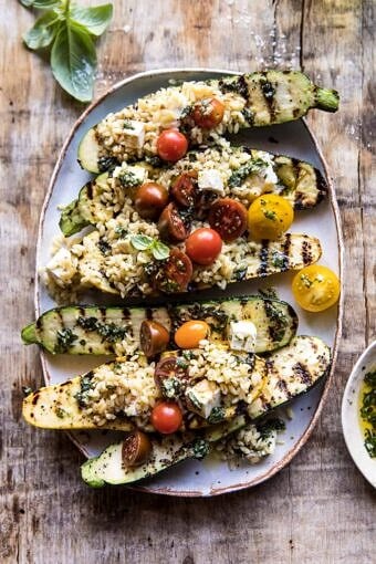 Grilled Pesto Zucchini Stuffed with Tomatoes and Orzo | halfbakedharvest.com #grilling #summer #easyrecipes