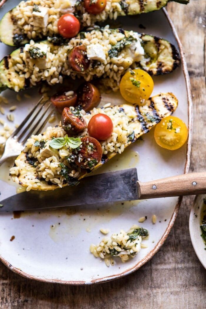 cute into photo of Grilled Pesto Zucchini Stuffed with Tomatoes and Orzo 