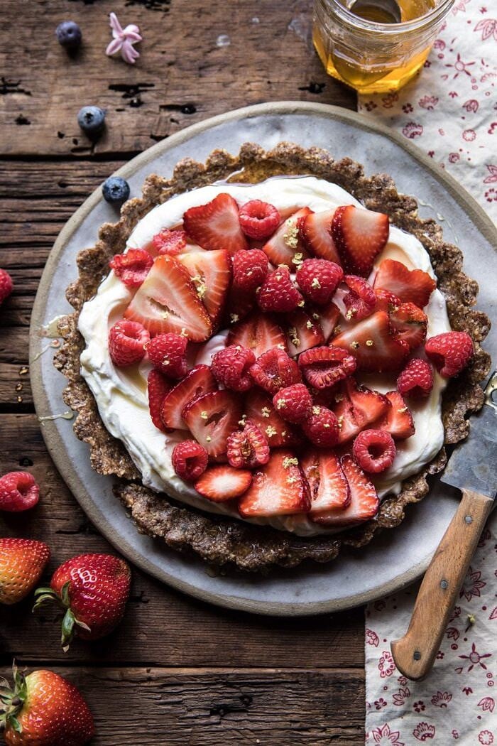 overhead photo of No Bake Greek Yogurt Fruit Tart with honey and spoon