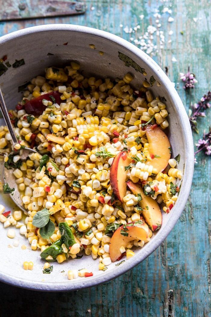 Spicy Corn and Peaches with Burrata | halfbakedharvest.com #summer #easyrecipe #salad angled photo of Spicy Corn and Peaches with Burrata in big salad bowl