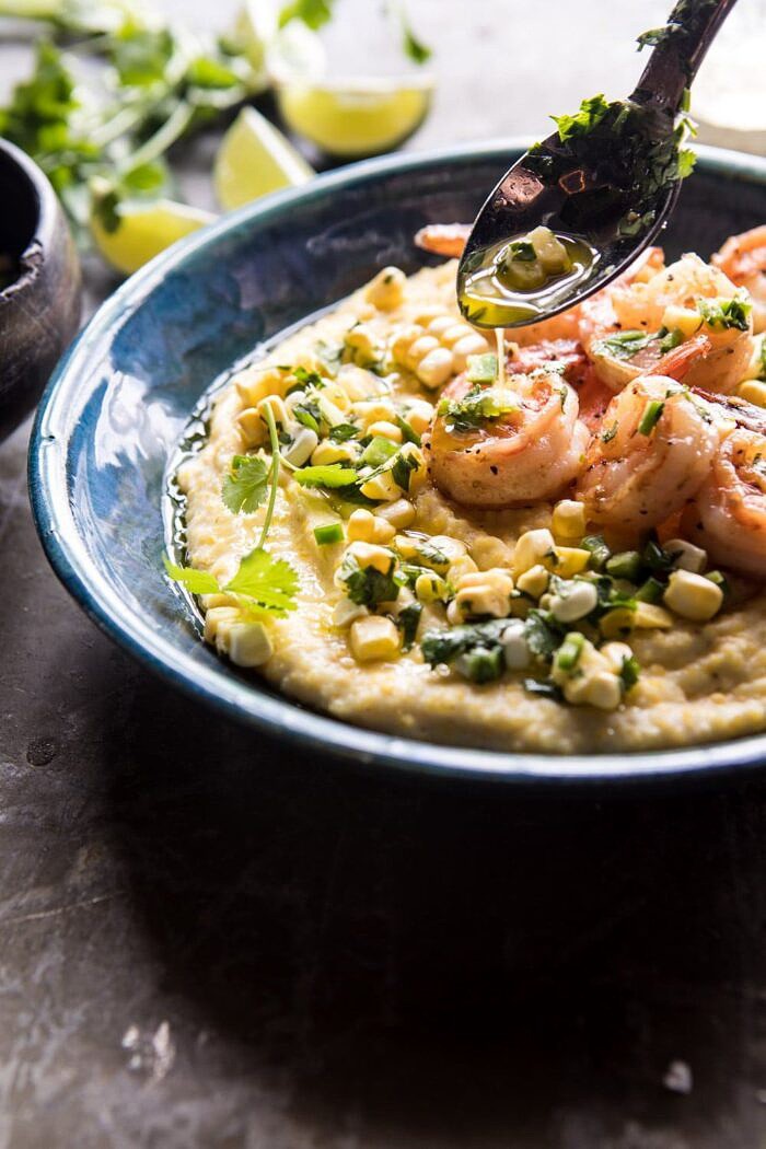 drizzling side angle photo of Sweet Corn Chimichurri Butter Shrimp with Polenta 