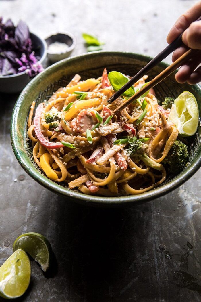 side angled photo of 20 Minute Sesame Basil Chicken Noodles with chopsticks going into the bowl