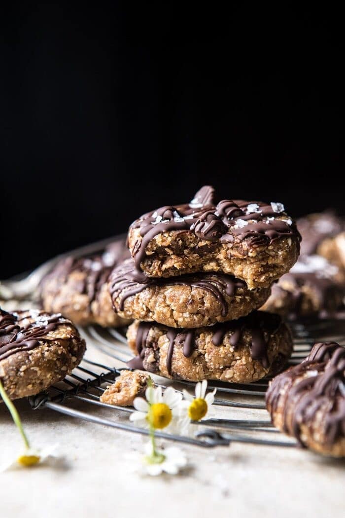 6 Ingredient No Bake Chocolate Chip Cookies | halfbakedharvest.com #cookies #healthy #chocolate #vegan #nobake 6 Ingredient No Bake Chocolate Chip Cookies stacked on top of each other with bite out of cookie