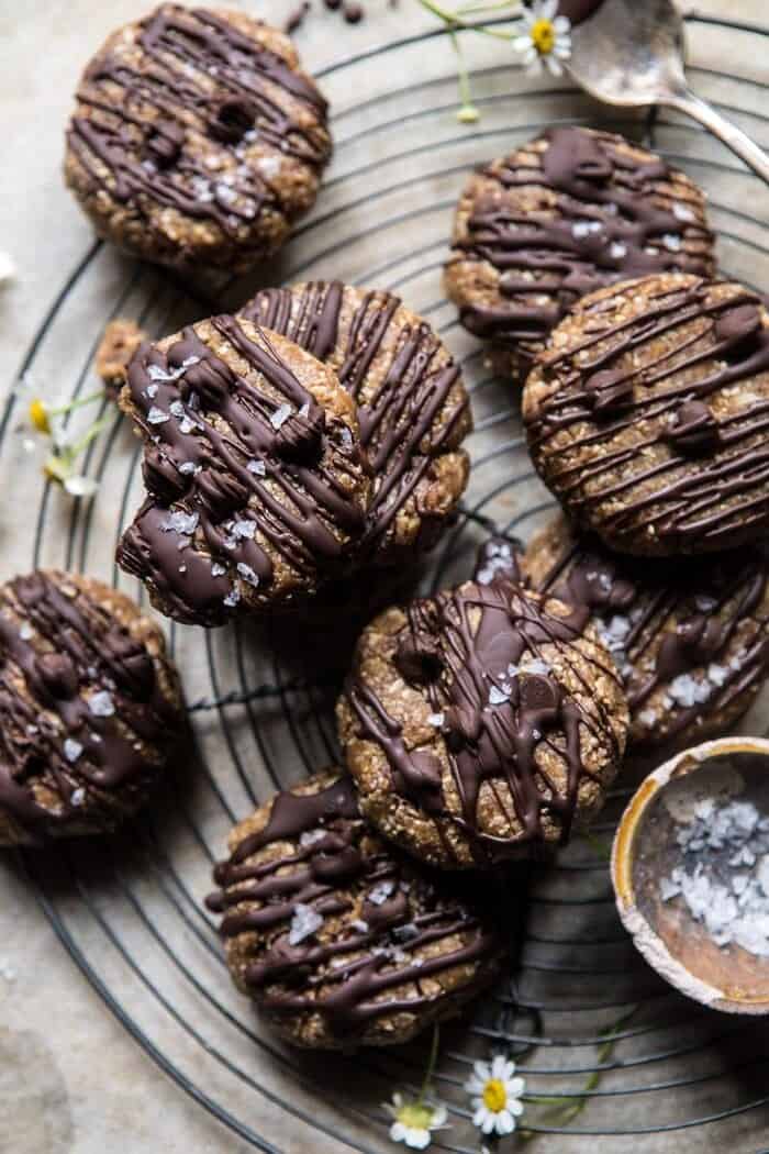 6 Ingredient No Bake Chocolate Chip Cookies | halfbakedharvest.com #cookies #healthy #chocolate #vegan #nobake overhead photo of 6 Ingredient No Bake Chocolate Chip Cookies with cookies stack and a bite out of 1 cookie