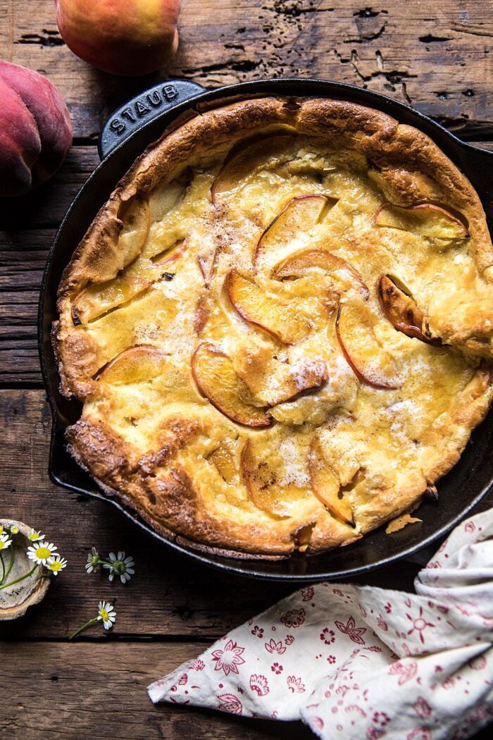 Browned Butter Cinnamon Peach Dutch Baby | halfbakedharvest.com #breakfast #brunch #peaches #peach #summer #pancake #easy overhead photo of Browned Butter Cinnamon Peach Dutch Baby