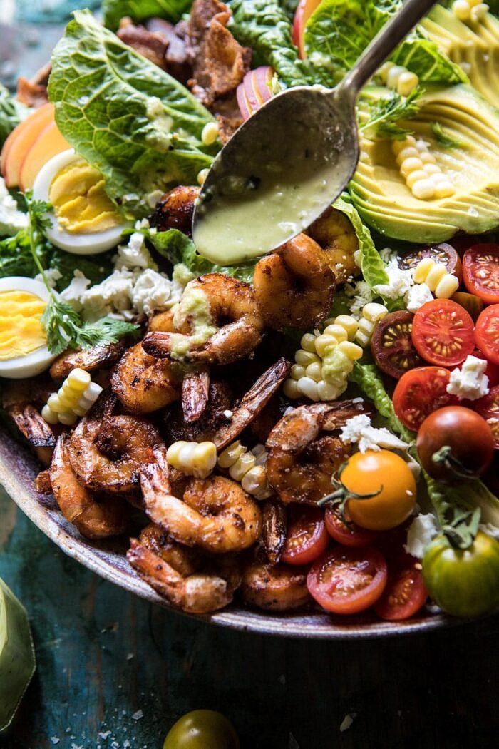 Chipotle Shrimp Cobb Salad with Jalapeno Corn Vinaigrette | halfbakedharvest.com #shrimp #salad #summerrecipes #mexican photo of drizzling vinaigrette one chipotle shrimp salad