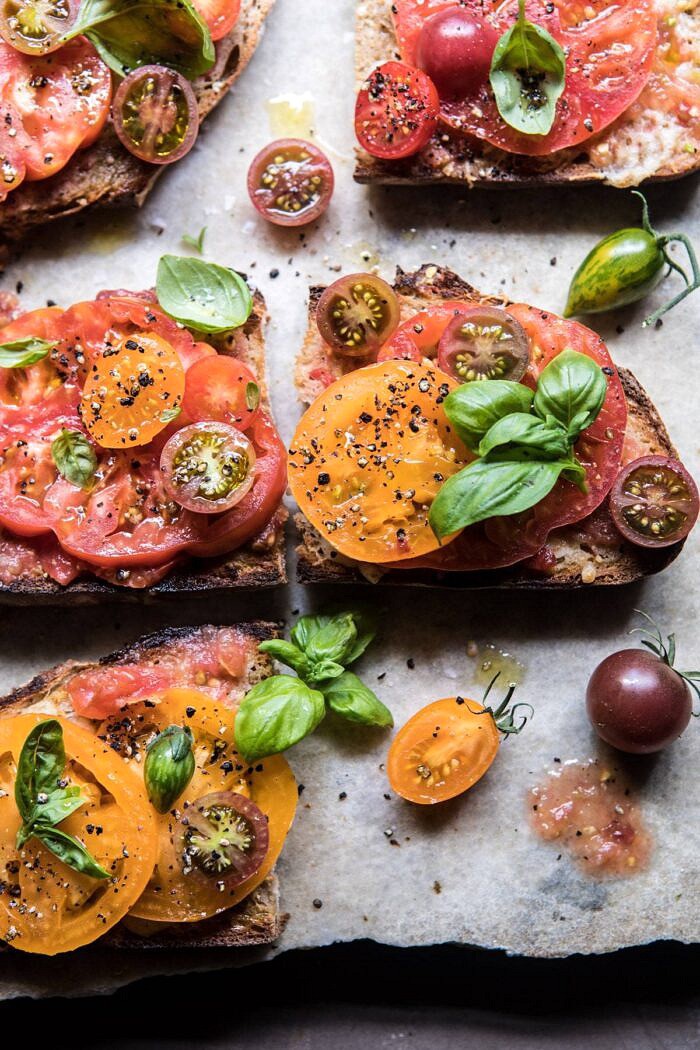 Heirloom Tomato, Basil, and Manchego Toast | halfbakedharvest.com #tomatoes #basil #easyrecipes #summerrecipes close up photo of Heirloom Tomato, Basil, and Manchego Toast