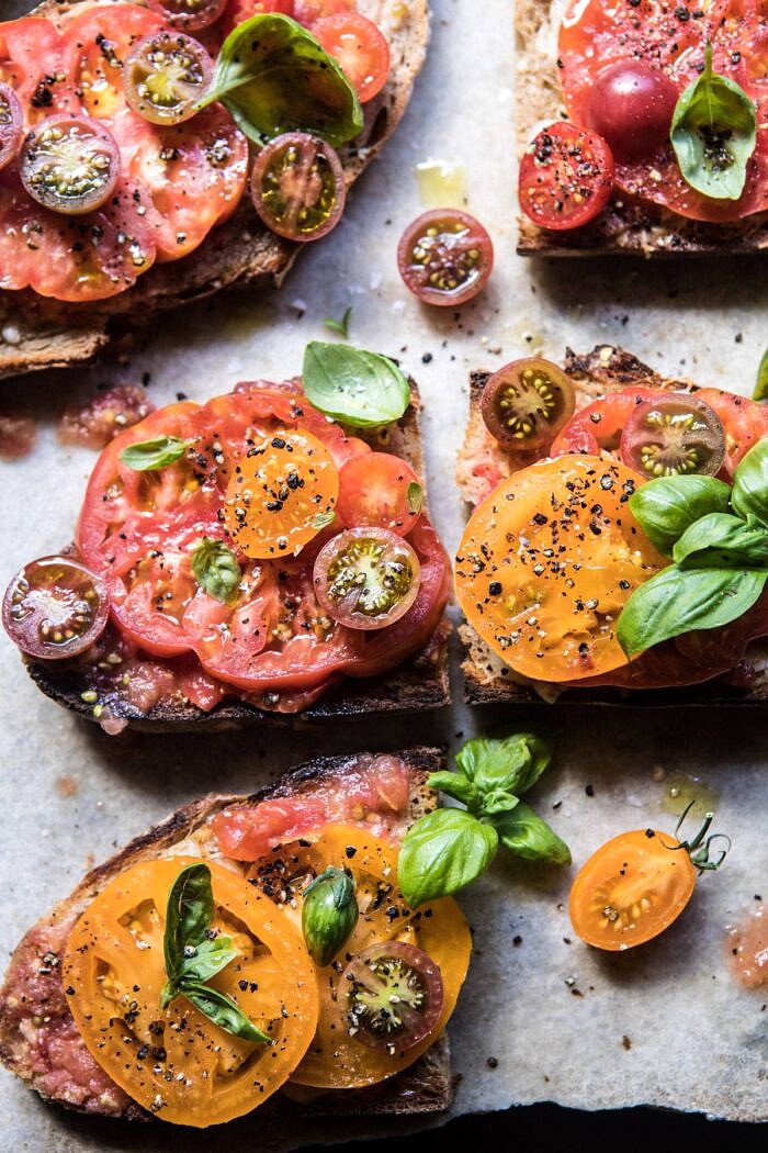 Heirloom Tomato, Basil, and Manchego Toast | halfbakedharvest.com #tomatoes #basil #easyrecipes #summerrecipes close up overhead photo of Heirloom Tomato, Basil, and Manchego Toast