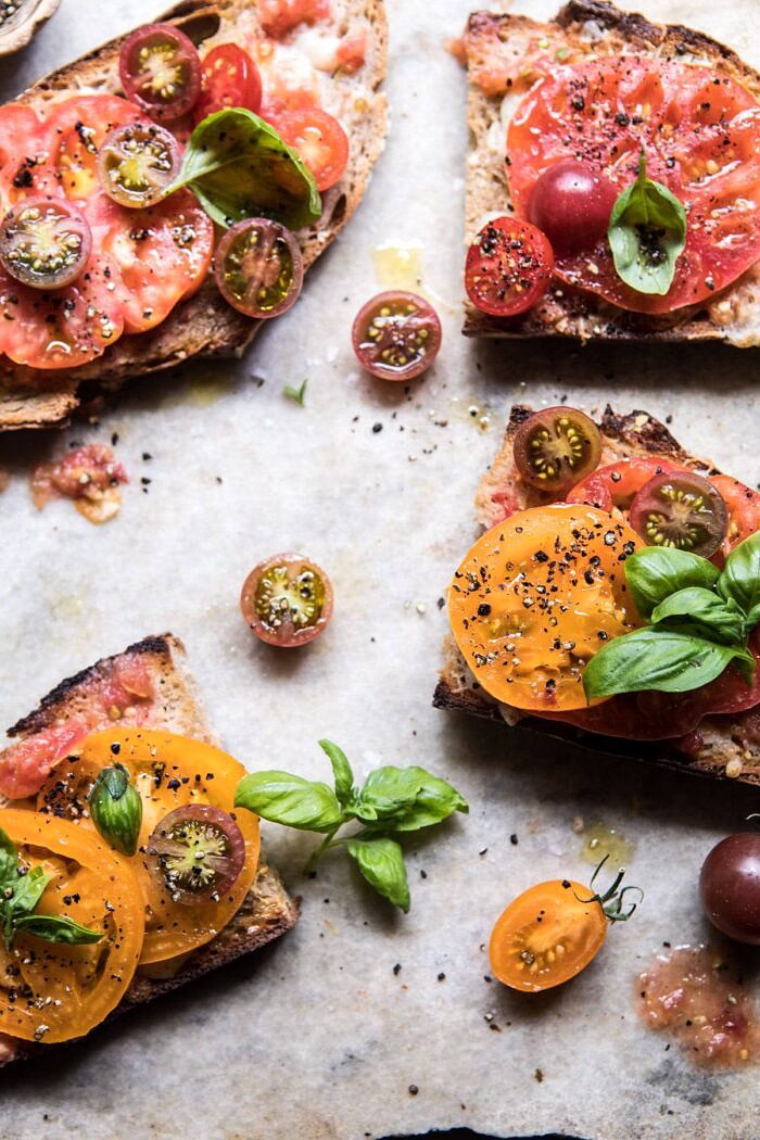 Heirloom Tomato, Basil, and Manchego Toast | halfbakedharvest.com #tomatoes #basil #easyrecipes #summerrecipes overhead photo of Heirloom Tomato, Basil, and Manchego Toast