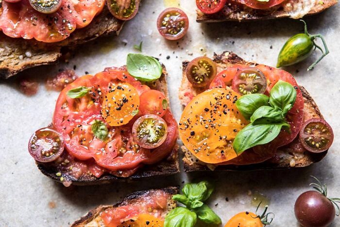 Heirloom Tomato, Basil, and Manchego Toast | halfbakedharvest.com #tomatoes #basil #easyrecipes #summerrecipes horizontal photo of Heirloom Tomato, Basil, and Manchego Toast