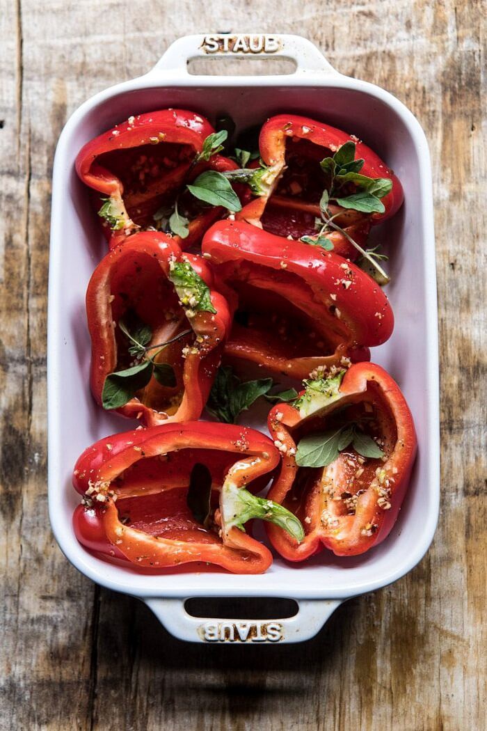 Greek Orzo Stuffed Red Peppers with Lemony Basil Tomatoes | halfbakedharvest.com #healthy #summerrecipes #easy #dinner #greek overhead photo of raw red peppers in roasting pan