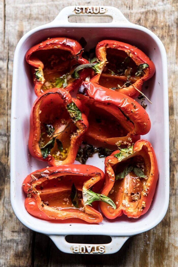 Greek Orzo Stuffed Red Peppers with Lemony Basil Tomatoes | halfbakedharvest.com #healthy #summerrecipes #easy #dinner #greek overhead photo of roasted red peppers in baking dish