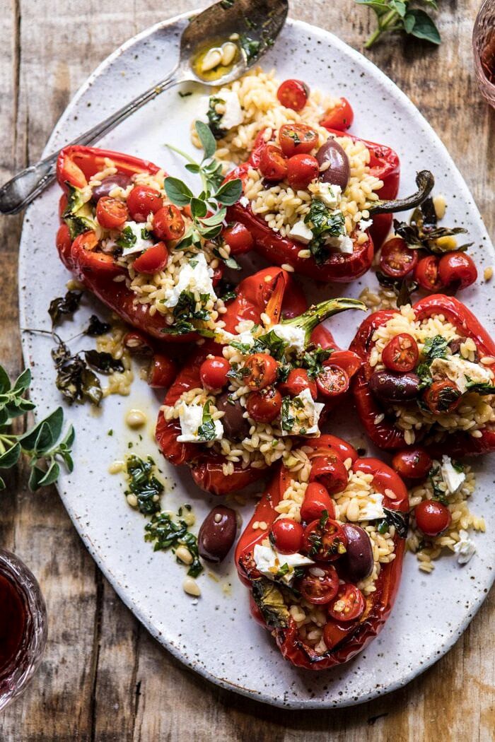 Greek Orzo Stuffed Red Peppers with Lemony Basil Tomatoes | halfbakedharvest.com #healthy #summerrecipes #easy #dinner #greek overhead close up photo of Greek Orzo Stuffed Red Peppers with Lemony Basil Tomatoes