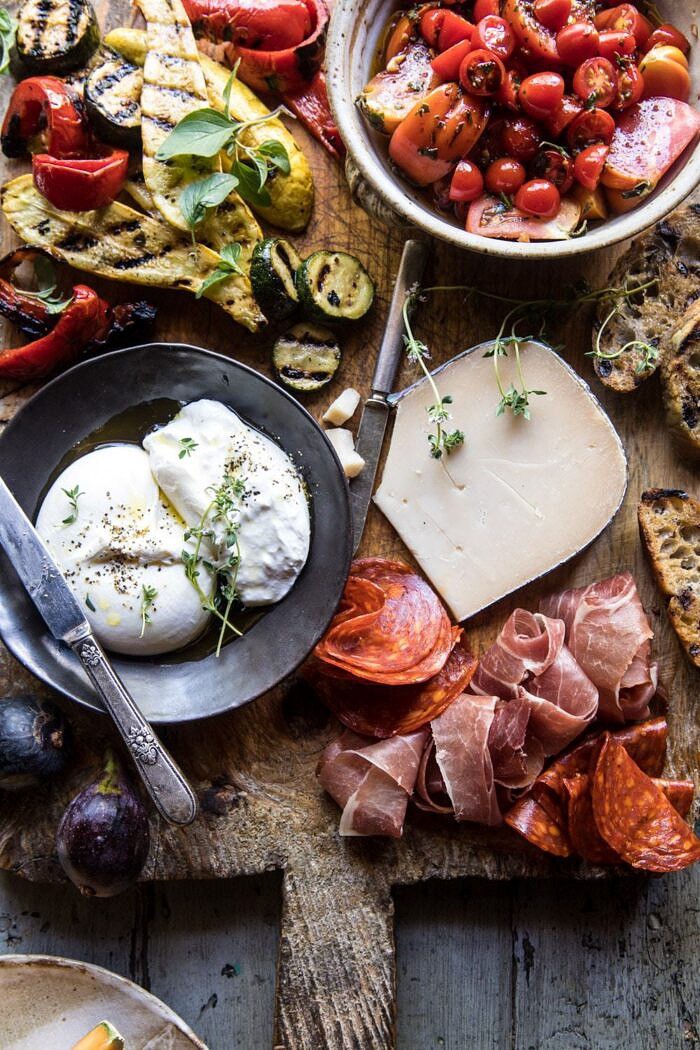 close up overhead photo of Marinated Tomato and Grilled Veggie Cheese Board 