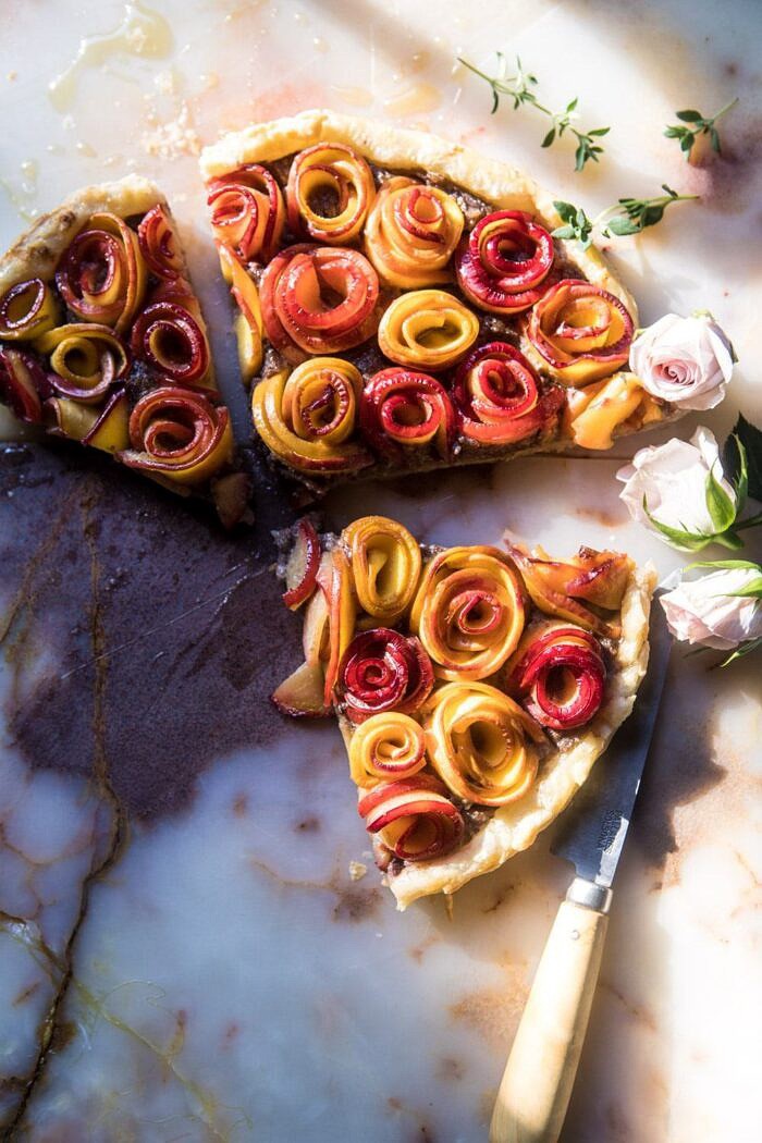 overhead photo of Sweet Peach Rose Tart cut into 3 triangles with sun streaking through 