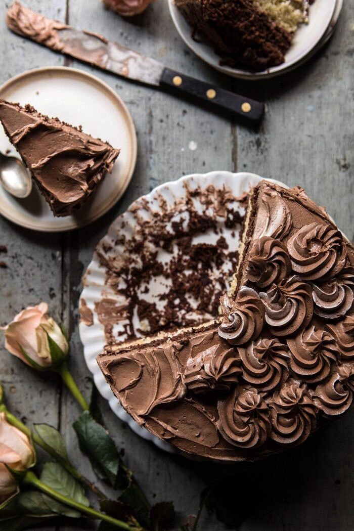 overhead photo of Better Together Chocolate Vanilla Birthday Cake with cake slices missing