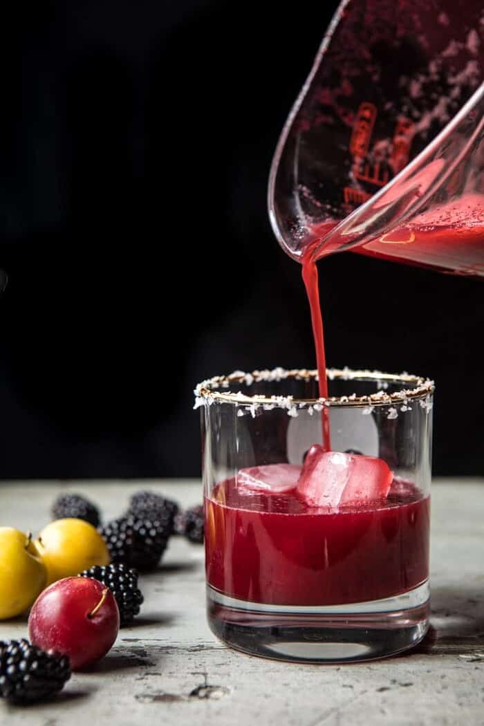 Blackberry Thyme Margarita being poured over ice