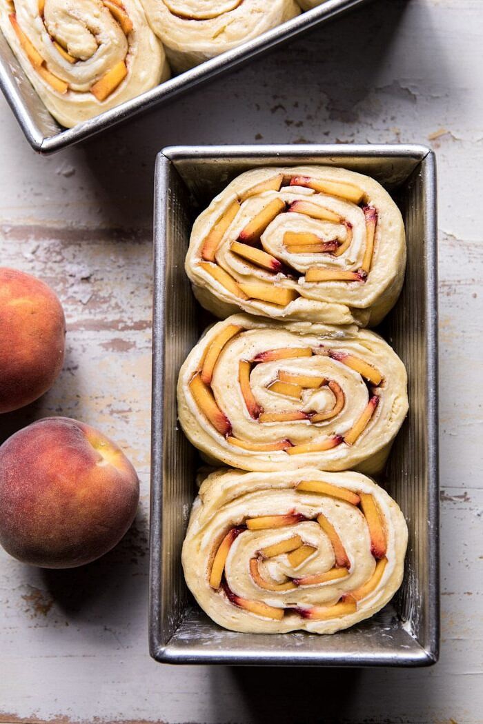 overhead photo of Flaky Pull Apart Cinnamon Peach Brioche Bread before baking in bread pan