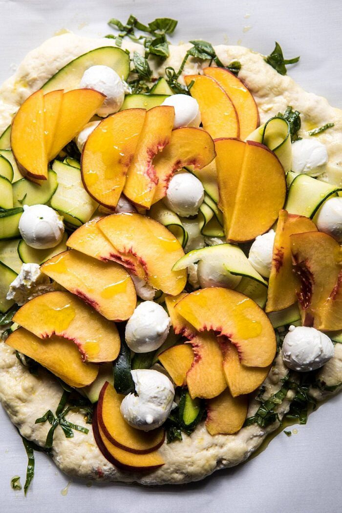 Pesto Zucchini and Peach Pizza with Burrata | halfbakedharvest.com #peach #pizza #summer #easyrecipes Pesto Zucchini and Peach Pizza with Burrata before going into the oven