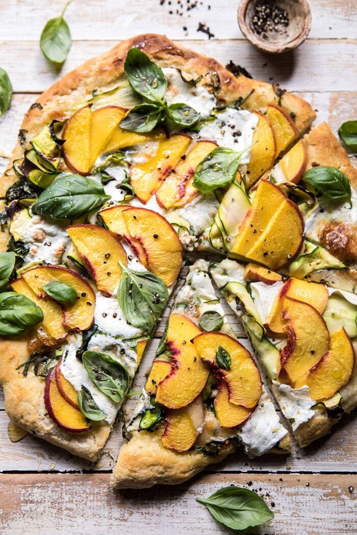 Pesto Zucchini and Peach Pizza with Burrata | halfbakedharvest.com #peach #pizza #summer #easyrecipes Pesto Zucchini and Peach Pizza with Burrata with 2 slices cut