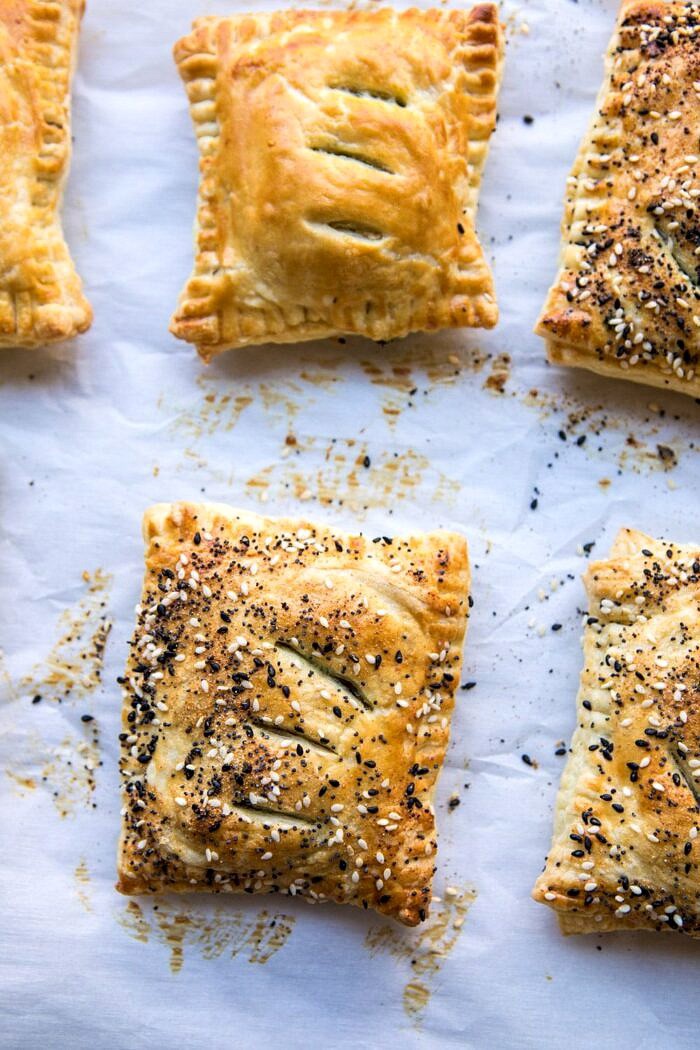 Caramelized Onion, Spinach, and Cheddar Flaky Pastries | halfbakedharvest.com #onions #tarts #fall #autumnrecipes #easy #holiday #appetizer Caramelized Onion, Spinach, and Cheddar Flaky Pastries on baking sheet after baking
