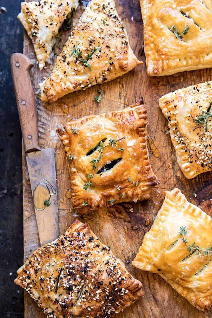 Caramelized Onion, Spinach, and Cheddar Flaky Pastries | halfbakedharvest.com #onions #tarts #fall #autumnrecipes #easy #holiday #appetizer overhead photo of Caramelized Onion, Spinach, and Cheddar Flaky Pastries