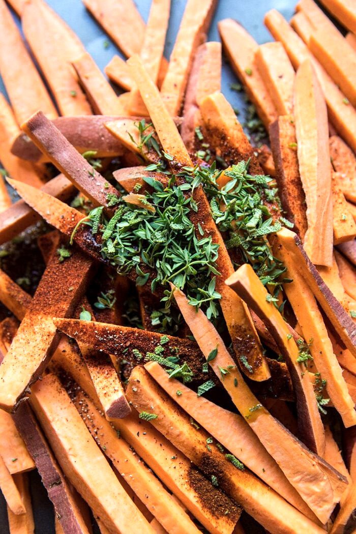 Herb Butter Baked Sweet Potato Fries | halfbakedharvest.com #quick #simple #easy #appetizers #sweetpotatoes #fallrecipes #autumn overhead photo of sweet potatoes fries before baking