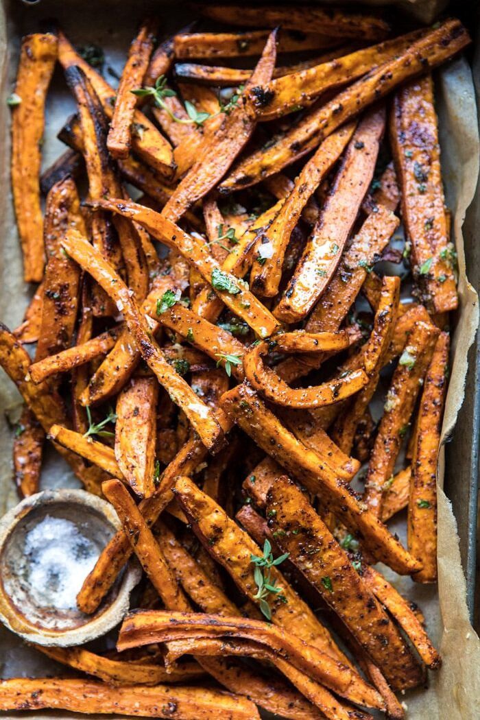 Herb Butter Baked Sweet Potato Fries | halfbakedharvest.com #quick #simple #easy #appetizers #sweetpotatoes #fallrecipes #autumn overhead close up photo of Herb Butter Baked Sweet Potato Fries in serving dish