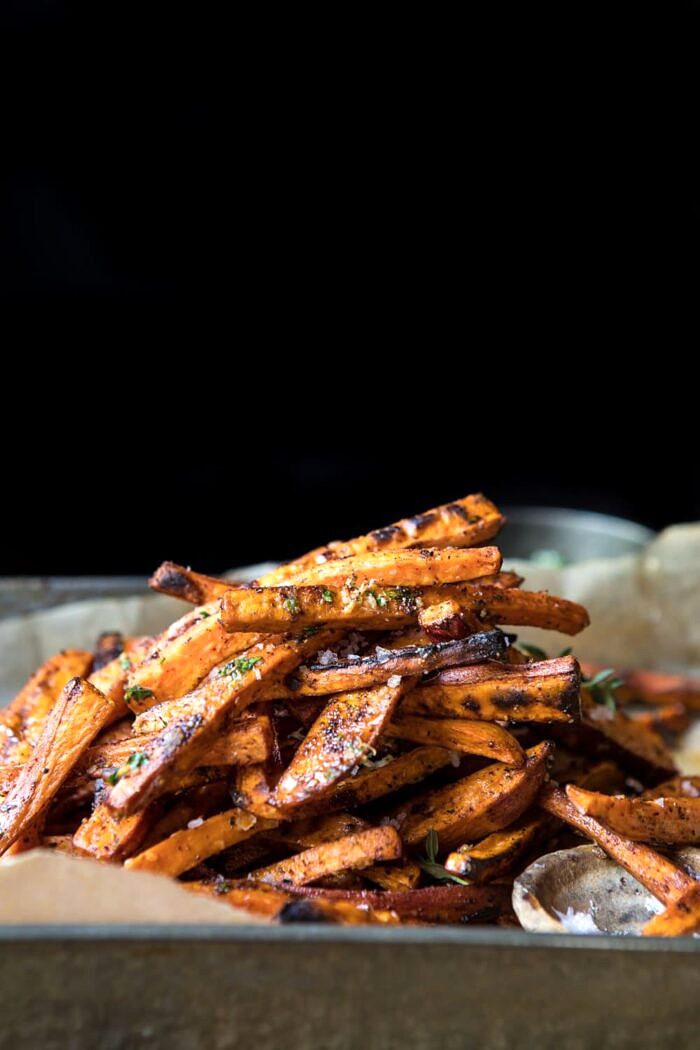Herb Butter Baked Sweet Potato Fries | halfbakedharvest.com #quick #simple #easy #appetizers #sweetpotatoes #fallrecipes #autumn side angle photo of Herb Butter Baked Sweet Potato Fries
