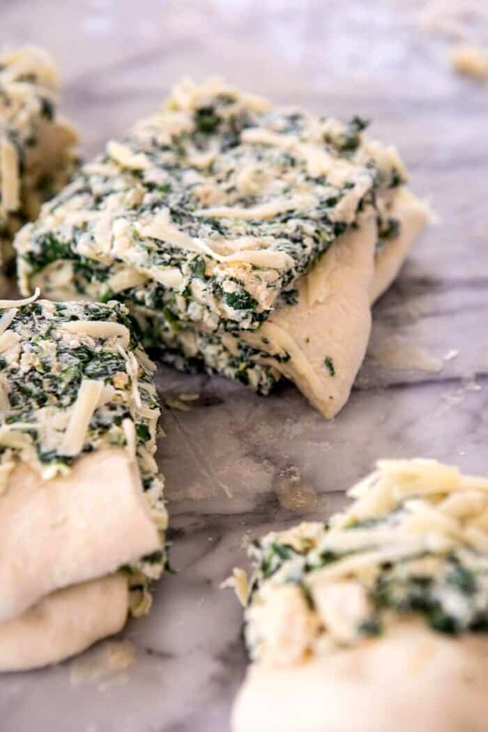 Herbed Spinach and Artichoke Pull Apart Pretzel Bread | halfbakedharvest.com #bread #appetizer #gamedayrecipes #easyrecipes Herbed Spinach and Artichoke Pull Apart Pretzel Bread dough stacked before baking