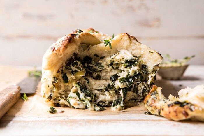 Herbed Spinach and Artichoke Pull Apart Pretzel Bread | halfbakedharvest.com #bread #appetizer #gamedayrecipes #easyrecipes horizontal, front on photo of Herbed Spinach and Artichoke Pull Apart Pretzel Bread