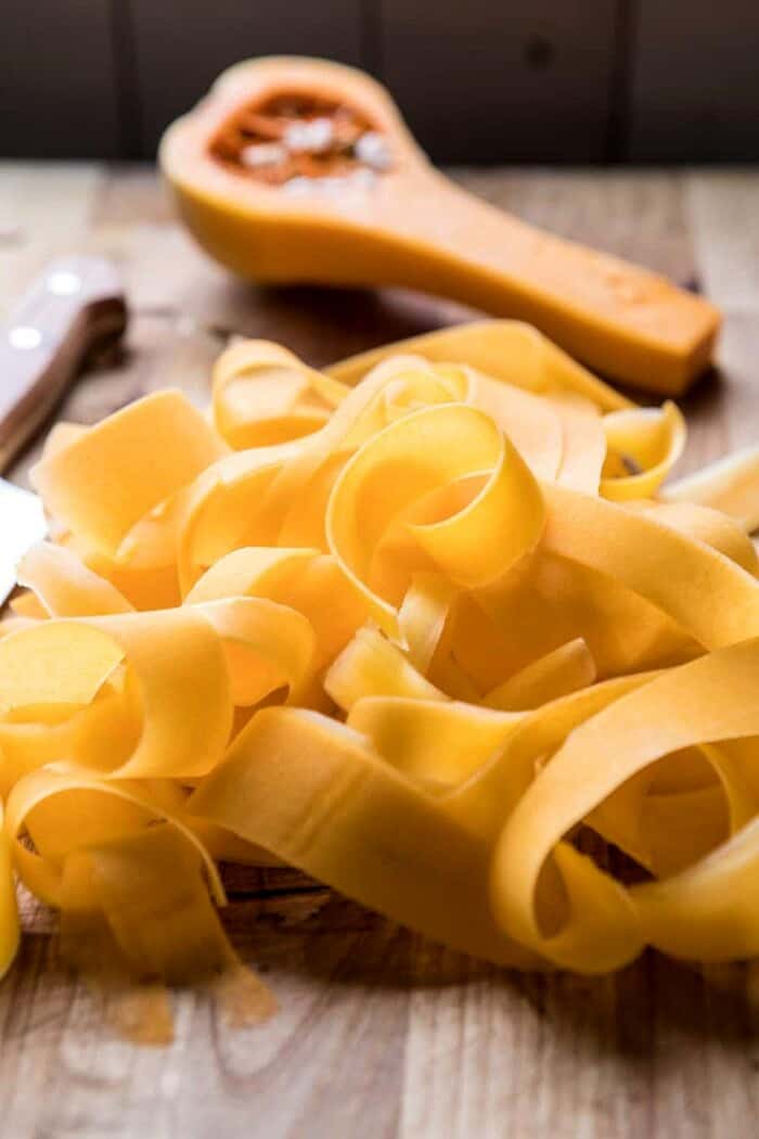 raw butternut squash ribbons on cutting board 