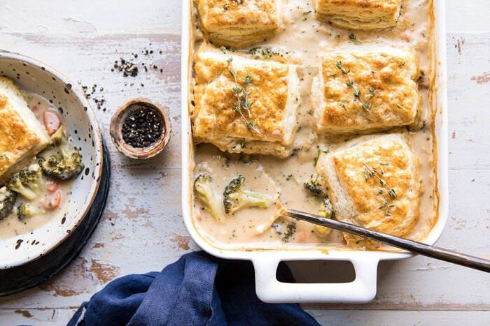 Homemade Broccoli Cheddar Cobbler | halfbakedharvest.com #broccoli #cheddar #soup #casserole #fallrecipes horizontal photo of Homemade Broccoli Cheddar Cobbler with spoon is baking dish