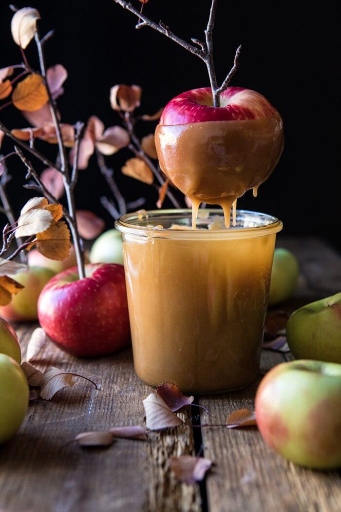 apples being dipped in caramel 