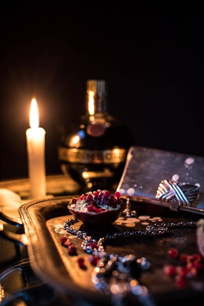 The Half Blood Prince Cocktail | halfbakedharvest.com #cocktails #halloween #pomegranate #fall #autumn photo of pomegranate on serving trey