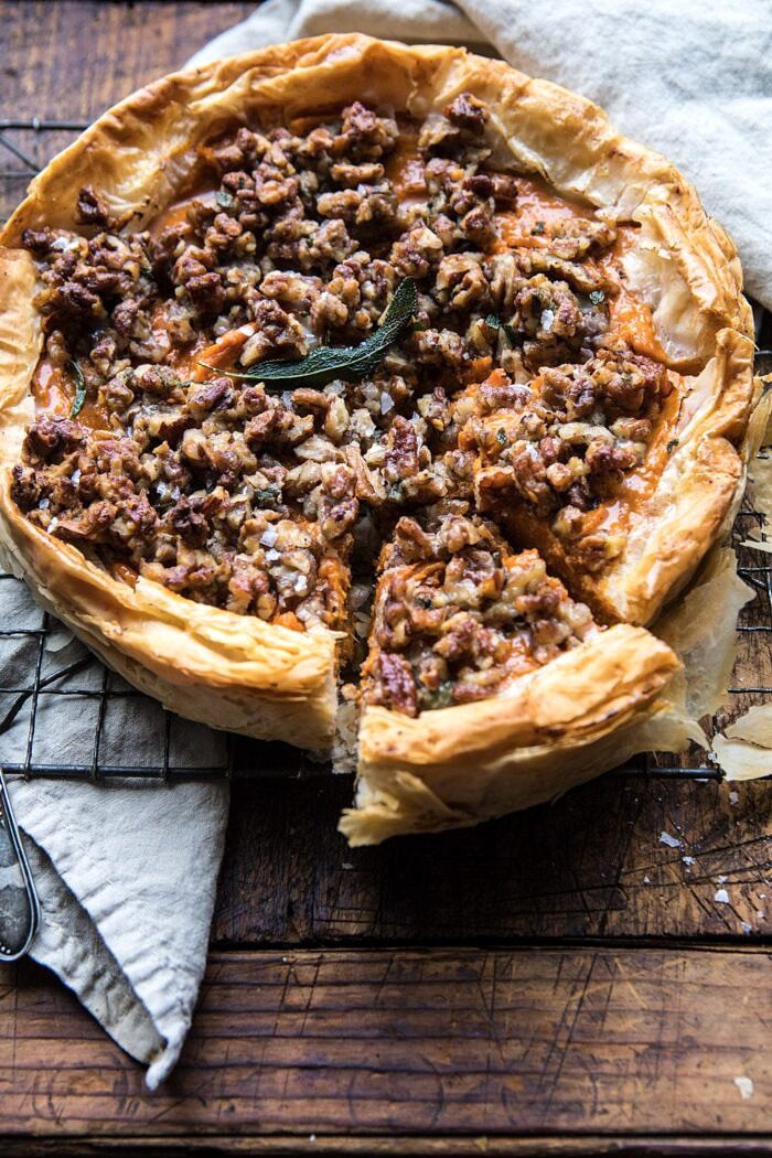 Bourbon Pecan Sweet Potato Phyllo Casserole | halfbakedharvest.com #sweetpotato #thanksgiving #holidayrecipes #fall #autumn side angle photo of Bourbon Pecan Sweet Potato Phyllo Casserole with pice cut out