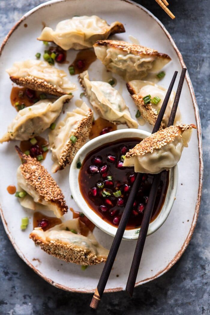 Ginger Sesame Chicken Potstickers with Sweet Chili Pomegranate Sauce | halfbakedharvest.com #asianrecipes #potstickers #dumplings #healthy overhead close up photo of Ginger Sesame Chicken Potstickers with Sweet Chili Pomegranate Sauce