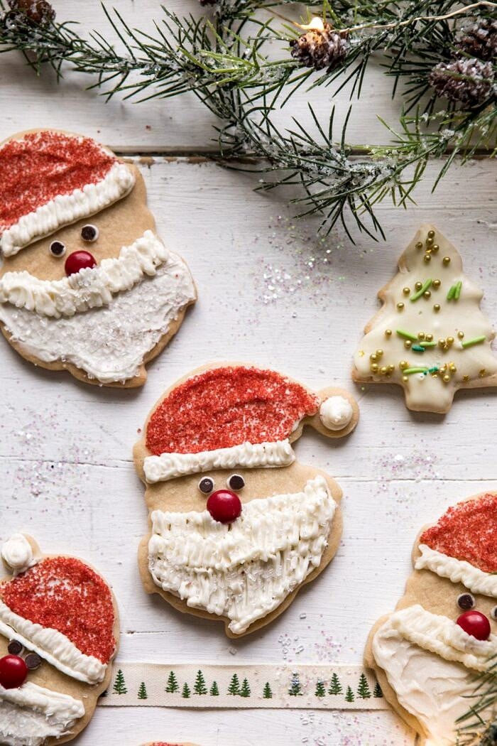 Chai Spiced Santa Cookies with White Chocolate Frosting | halfbakedharvest.com #sugarcookies #christmas #holiday #chai #dessert #easyrecipes overhead close up photo of Chai Spiced Santa Cookies with White Chocolate Frosting
