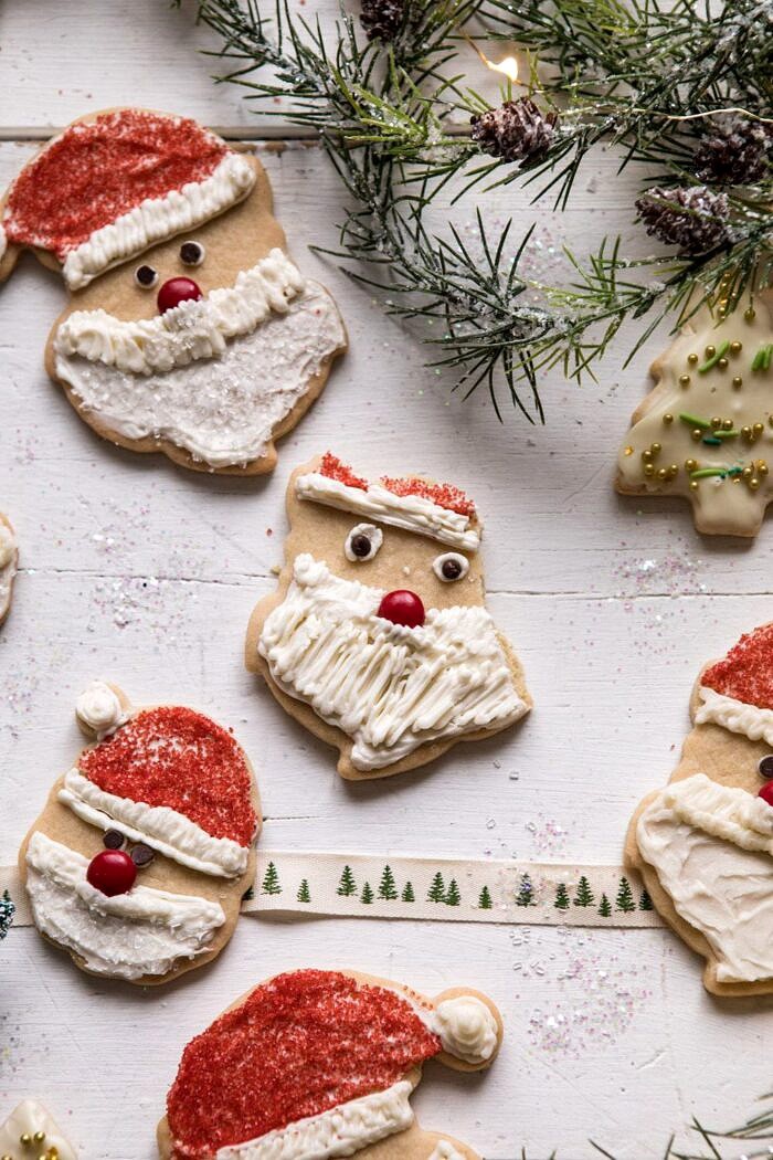Chai Spiced Santa Cookies with White Chocolate Frosting | halfbakedharvest.com #sugarcookies #christmas #holiday #chai #dessert #easyrecipes half eaten Chai Spiced Santa Cookies with White Chocolate Frosting