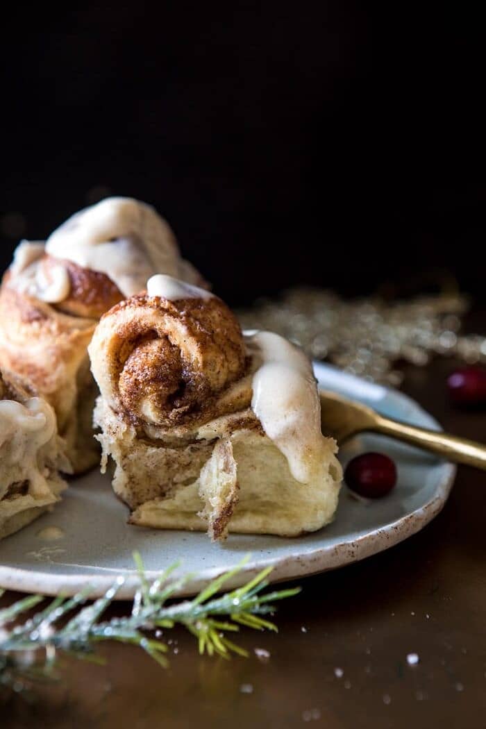 Easiest Overnight Eggnog Brioche Cinnamon Rolls | halfbakedharvest.com #cinnamonrolls #Christmas #easyrecipes #eggnog side angle photo of Easiest Overnight Eggnog Brioche Cinnamon Roll out of pan