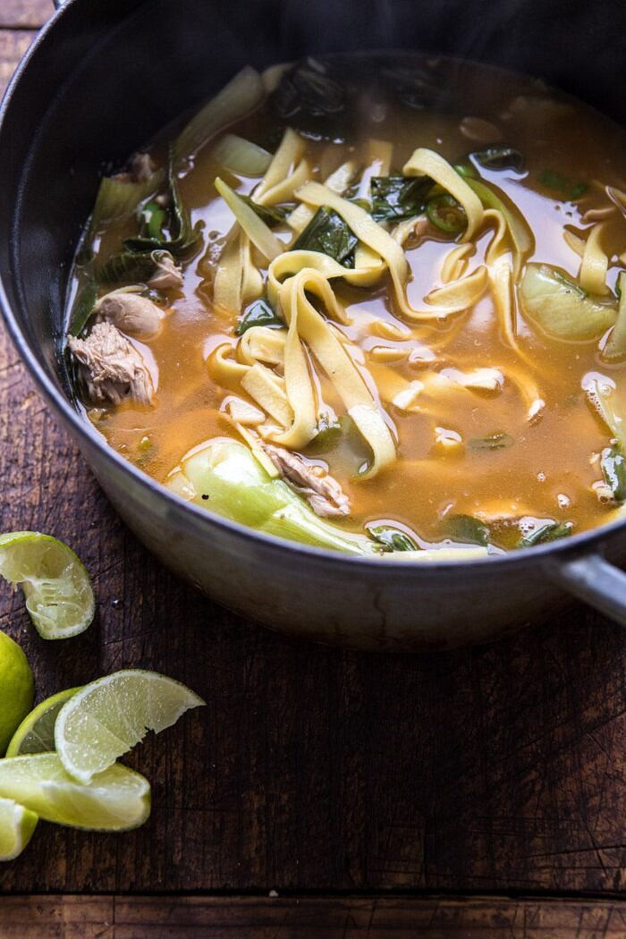 Ginger Peanut Chicken Noodle Soup | halfbakedharvest.com #soup #healthyrecipe #chickensoup #easyrecipes side angle photo of Ginger Peanut Chicken Noodle Soup in soup pot