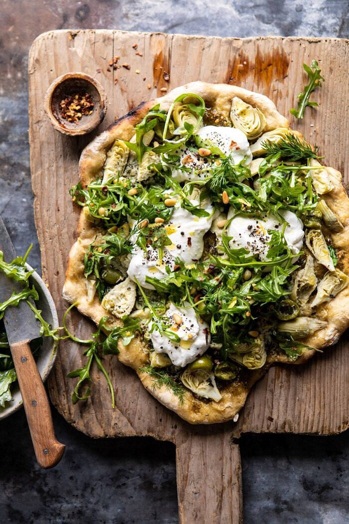 Artichoke Pesto and Burrata Pizza with Lemony Arugula | halfbakedharvest.com #pizza #healthy #burrata #easyrecipes Artichoke Pesto and Burrata Pizza with Lemony Arugula before being cut