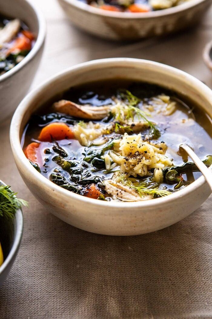 Lemony Garlic Chicken and Orzo Soup | halfbakedharvest.com #chickensoup #kale #healthyrecipes #winter side angle photo of Lemony Garlic Chicken and Orzo Soup