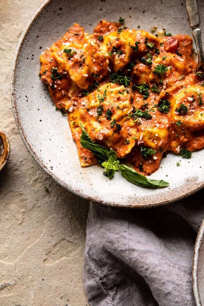 Brown Butter Lobster Ravioli with Tomato Cream Sauce | halfbakedharvest.com #ravioli #Italian #lobster #pastarecipes #pasta #valentinesday close up photo of Brown Butter Lobster Ravioli with Tomato Cream Sauce