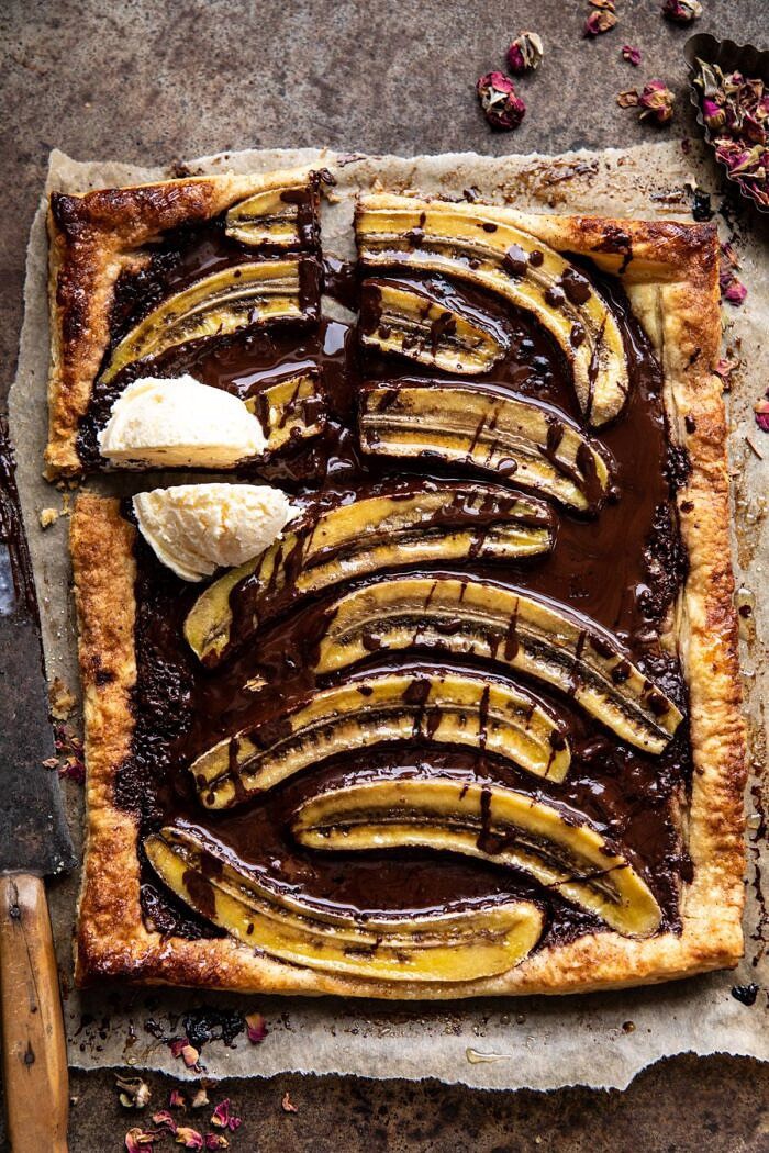 Warm Chocolate Banana Galette | halfbakedharvest.com #banana #chocolate #dessert #easyrecipes #chocolaterecipes #baking overhead photo of Warm Chocolate Banana Galette with square cut out and ice cream on top